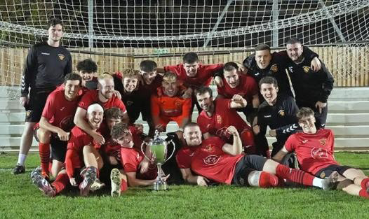 Dursley Town’s players celebrate after last night’s Reg Davis Cup final win. Picture: Brian Rossiter