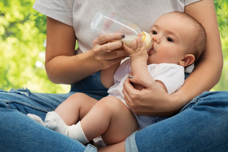 Mum bottle feeding baby