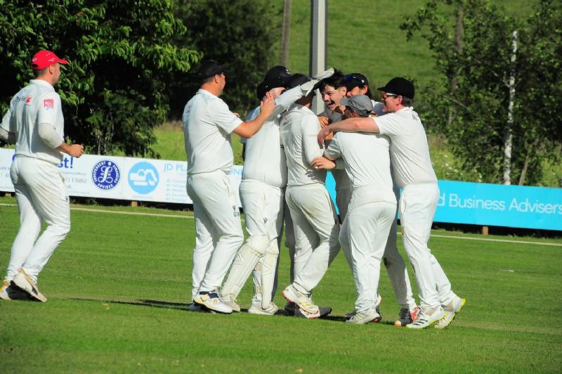 Luke Bond celebrates with his team-mates  after taking his 10th wicket for Kingsholm