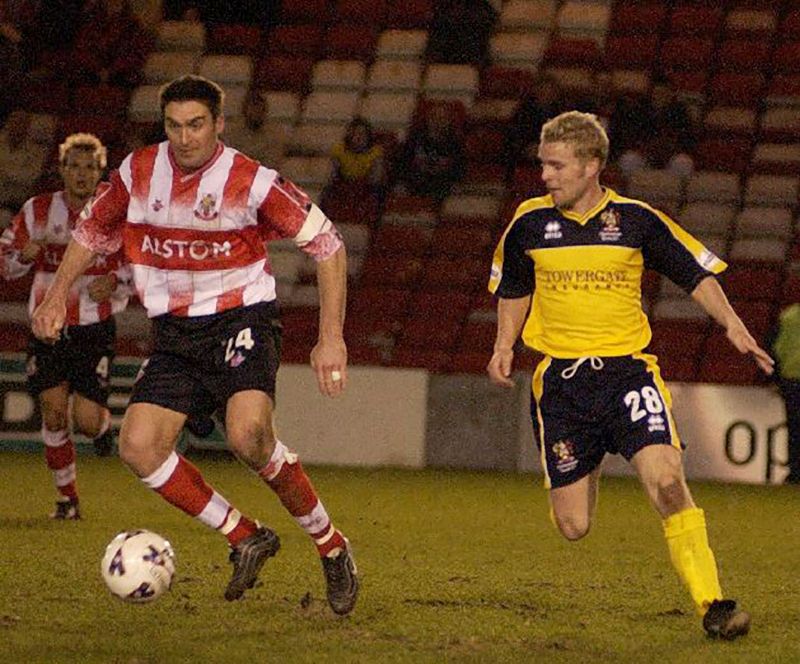 John Finnigan, right, in action for Cheltenham Town against former club Lincoln in March 2002. Picture, Lincolnshire Echo