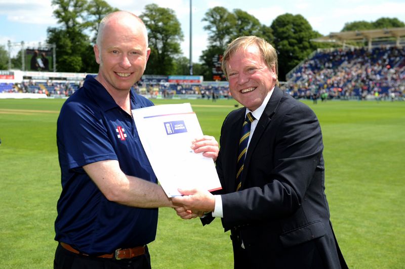 Gwyn Williams receives his award from ECB chief Huw Morris in 2015