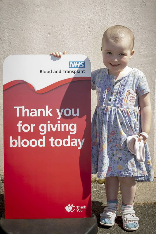 Poppy standing outside her local blood donor centre
