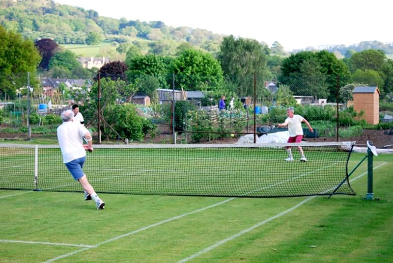 Members of Leckhampton Lawn Tennis Club play on two grasscourts