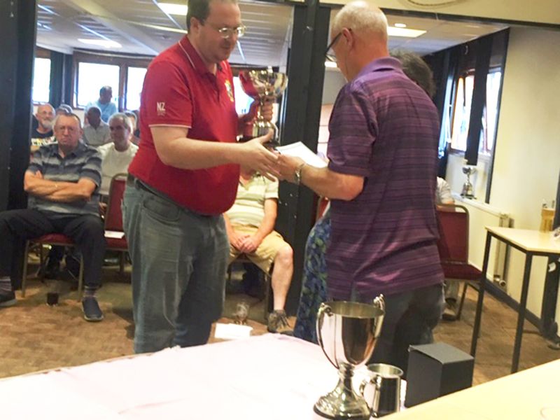 Stephen Price collecting the Front Pin Triples Trophy on behalf of Price Walker AFC 'C'.