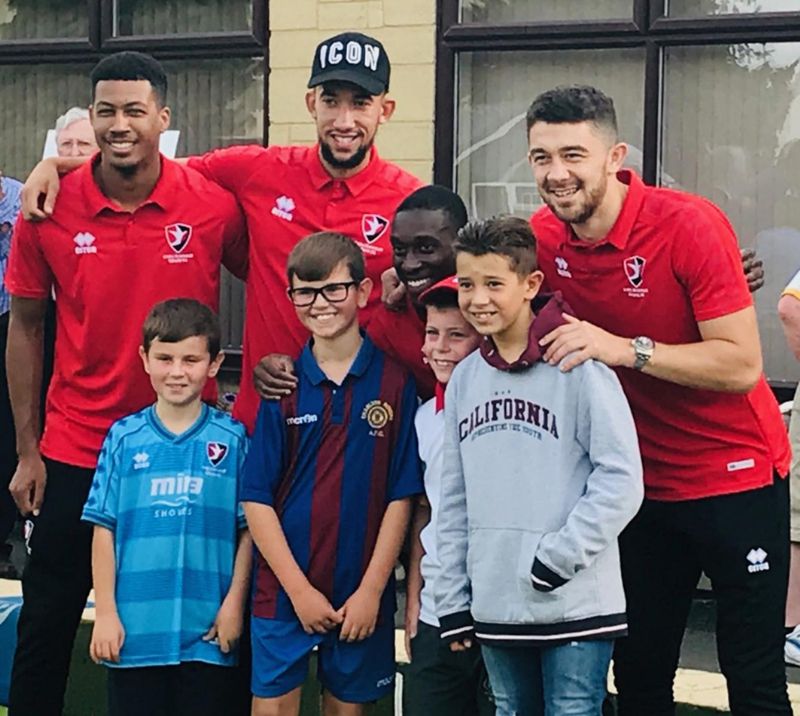 Cheltenham Town footballers pictured with some happy youngsters in support of the ‘Bowlsfest’ family event in aid of Special Olympics Gloucestershire at Cheltenham Bowling Club