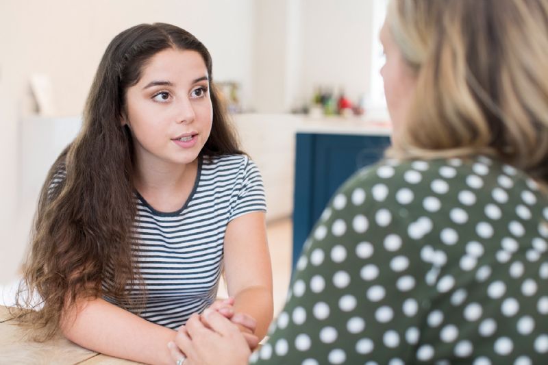 Young woman talking seriously with mother
