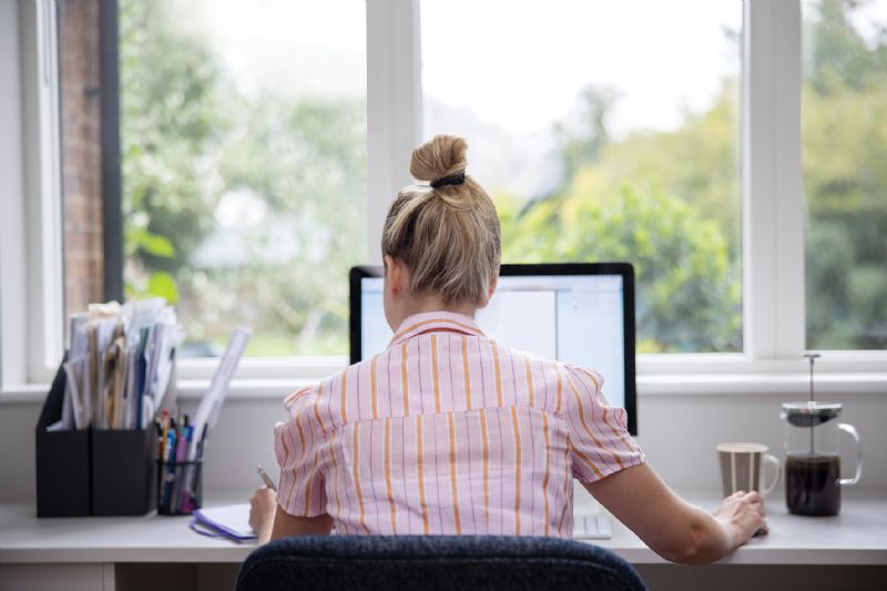 Woman sat at desk computer working from home