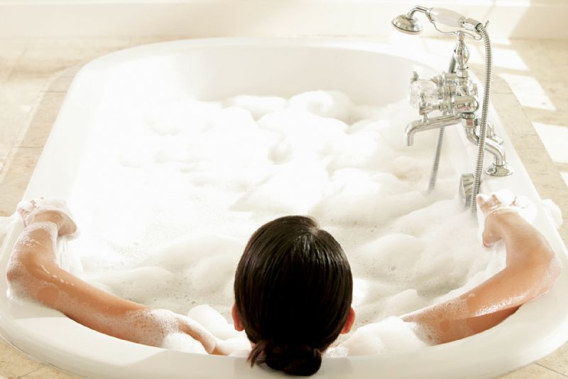 Woman relaxing in bath self-care
