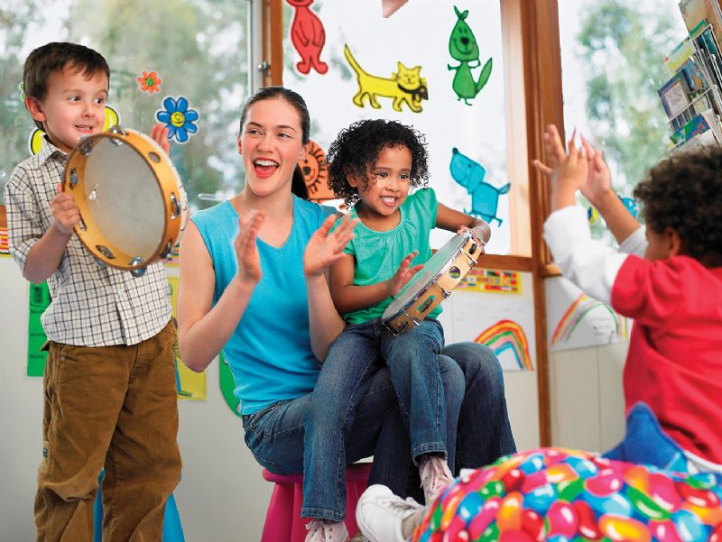 Young children playing music percussion