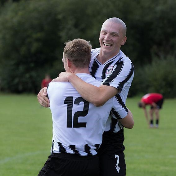 Winchcombe’s Monty New, right, celebrates a goal with Josh Allen